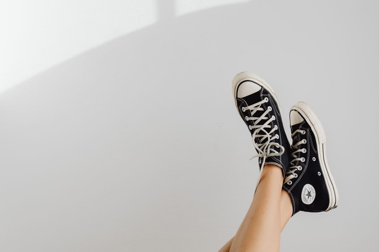 Home Black sneakers displayed against a white background, highlighting casual fashion style.